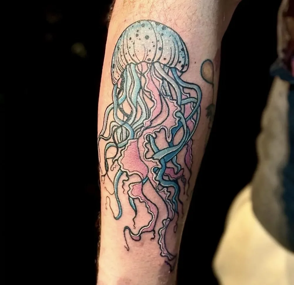 Jellyfish tattoo rendered in soft blue and pink